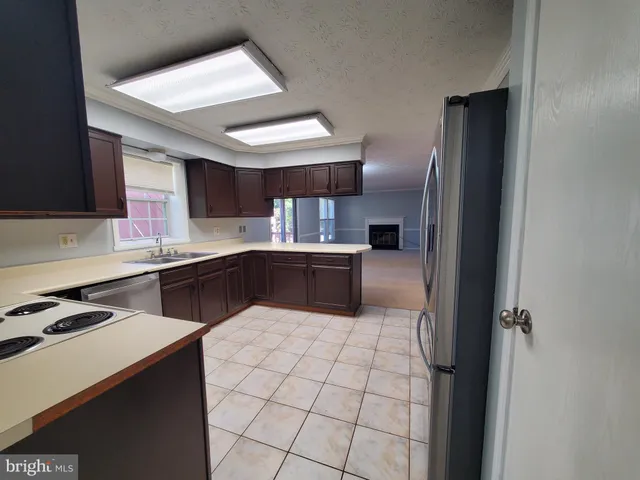 a kitchen with cabinets and stainless steel appliances