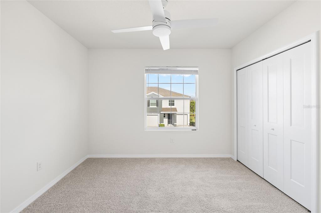 8502 Falling Blue Place Riverview, FL 33578 - Photo 14 of 32 an empty room with a window and ceiling fan