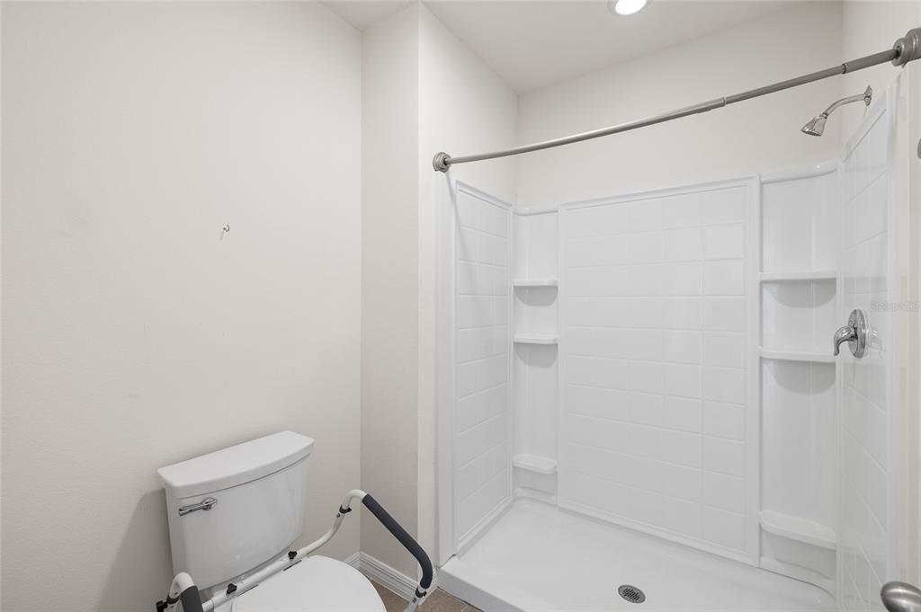 8502 Falling Blue Place Riverview, FL 33578 - Photo 16 of 32 a white toilet sitting next to a bath tub shower