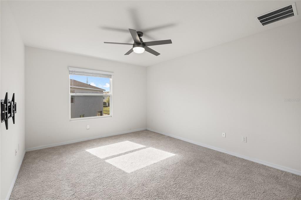 8502 Falling Blue Place Riverview, FL 33578 - Photo 20 of 32 an empty room with a empty space and windows