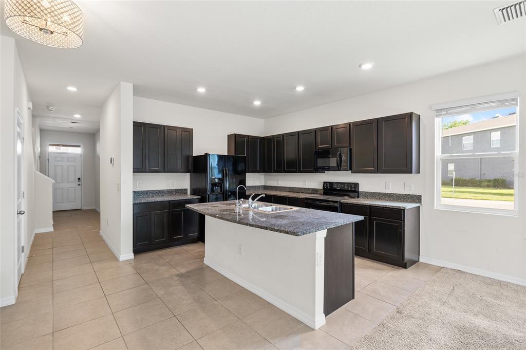8502 Falling Blue Place Riverview, FL 33578 - Photo 2 of 32 a kitchen with stainless steel appliances granite countertop a stove and a refrigerator