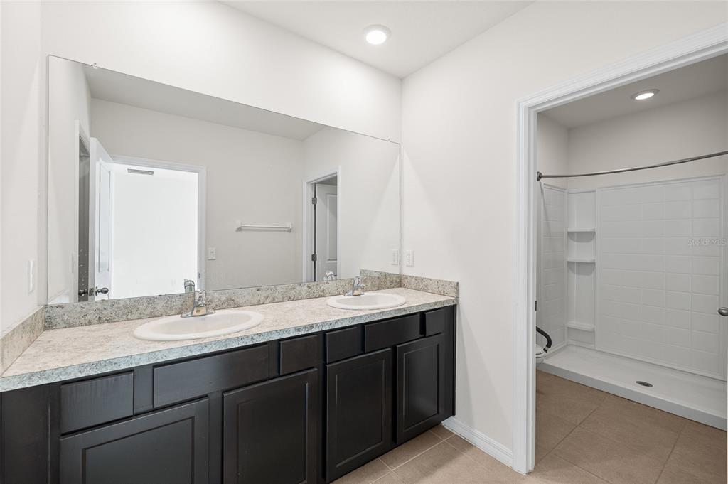 8502 Falling Blue Place Riverview, FL 33578 - Photo 3 of 32 a bathroom with a granite countertop sink mirror and double