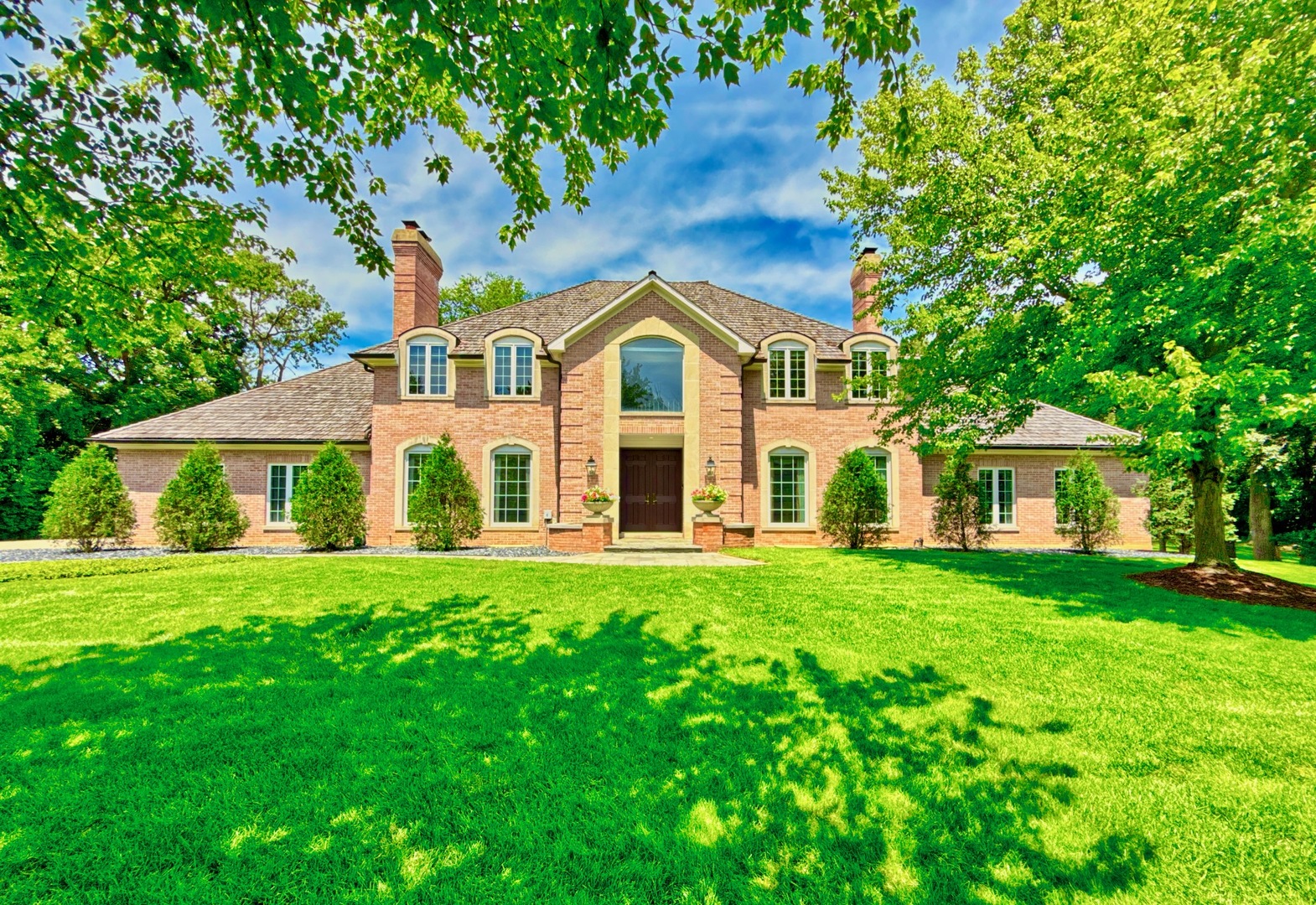 a front view of a house with a garden