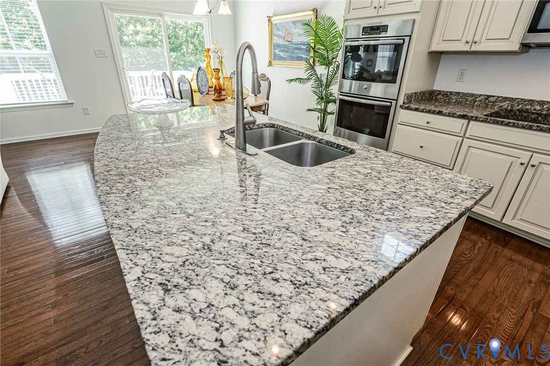 7435 Wicks Road Williamsburg, VA 23188 - Photo 31 of 82 Kitchen island featuring a double basin sink with
