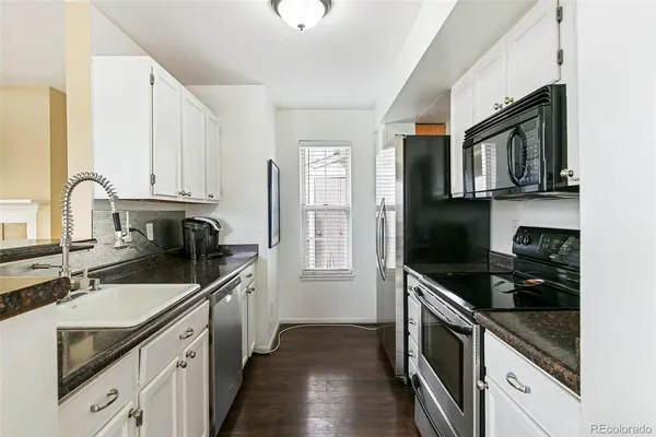 a kitchen that has a sink and a stove
