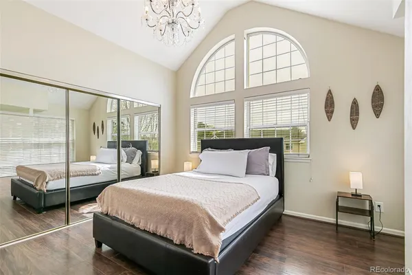 a bedroom with a bed and a large window with outer view