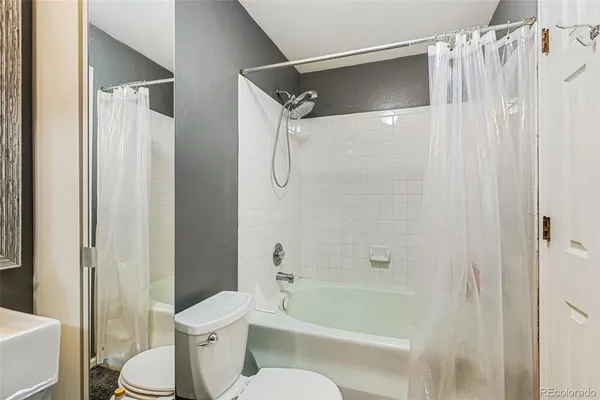 a bathroom with a shower a toilet and a shower