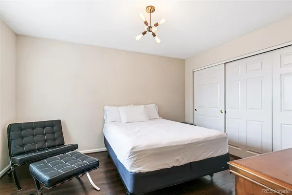 a bedroom with a bed and a dresser
