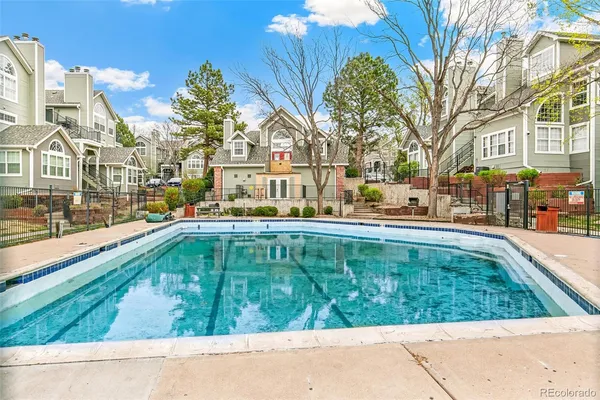 a swimming pool with outdoor seating and yard