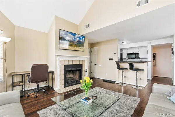a living room with furniture and a fireplace