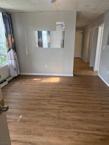 a view of room with window and wooden floor