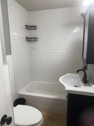 a bathroom with a sink a toilet and a bathtub