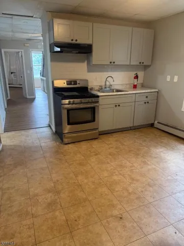 a kitchen with stainless steel appliances a sink a stove a microwave and cabinets