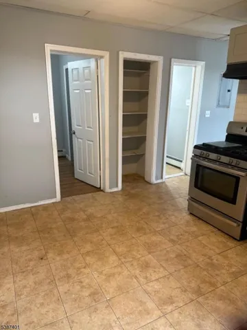 a view of a kitchen with storage and utility room