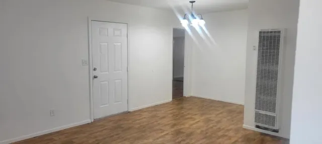 a view of storage and utility room with wooden floor