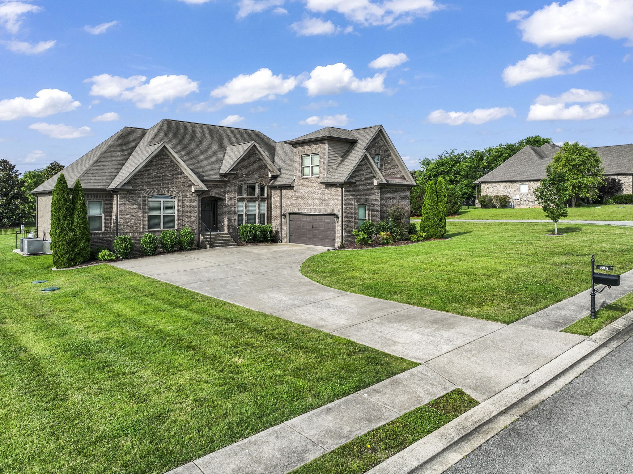 a front view of a house with a yard and garage