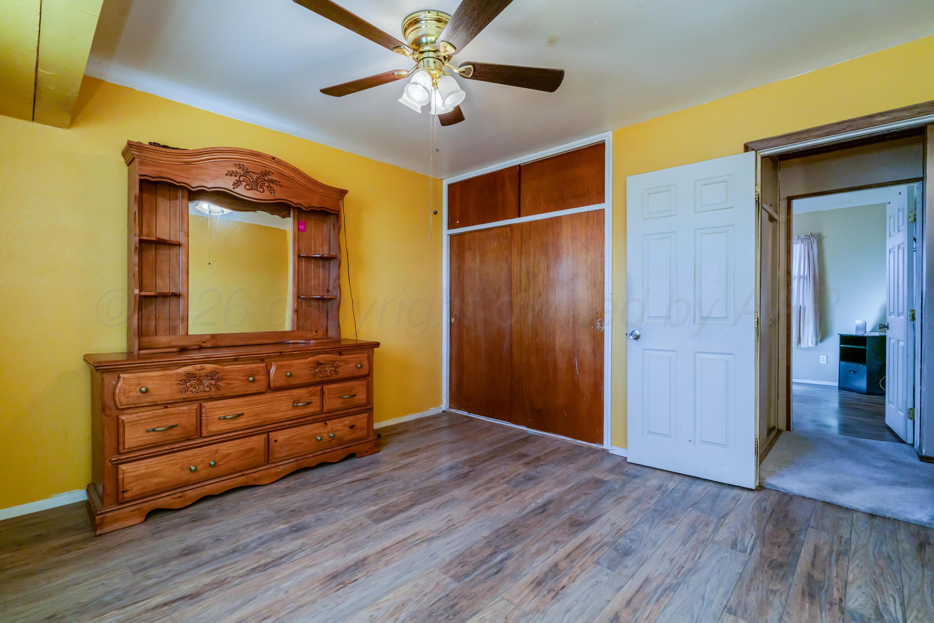 2805 Palm Street Amarillo, TX 79107 - Photo 12 of 17 a room with wooden floor and cabinet