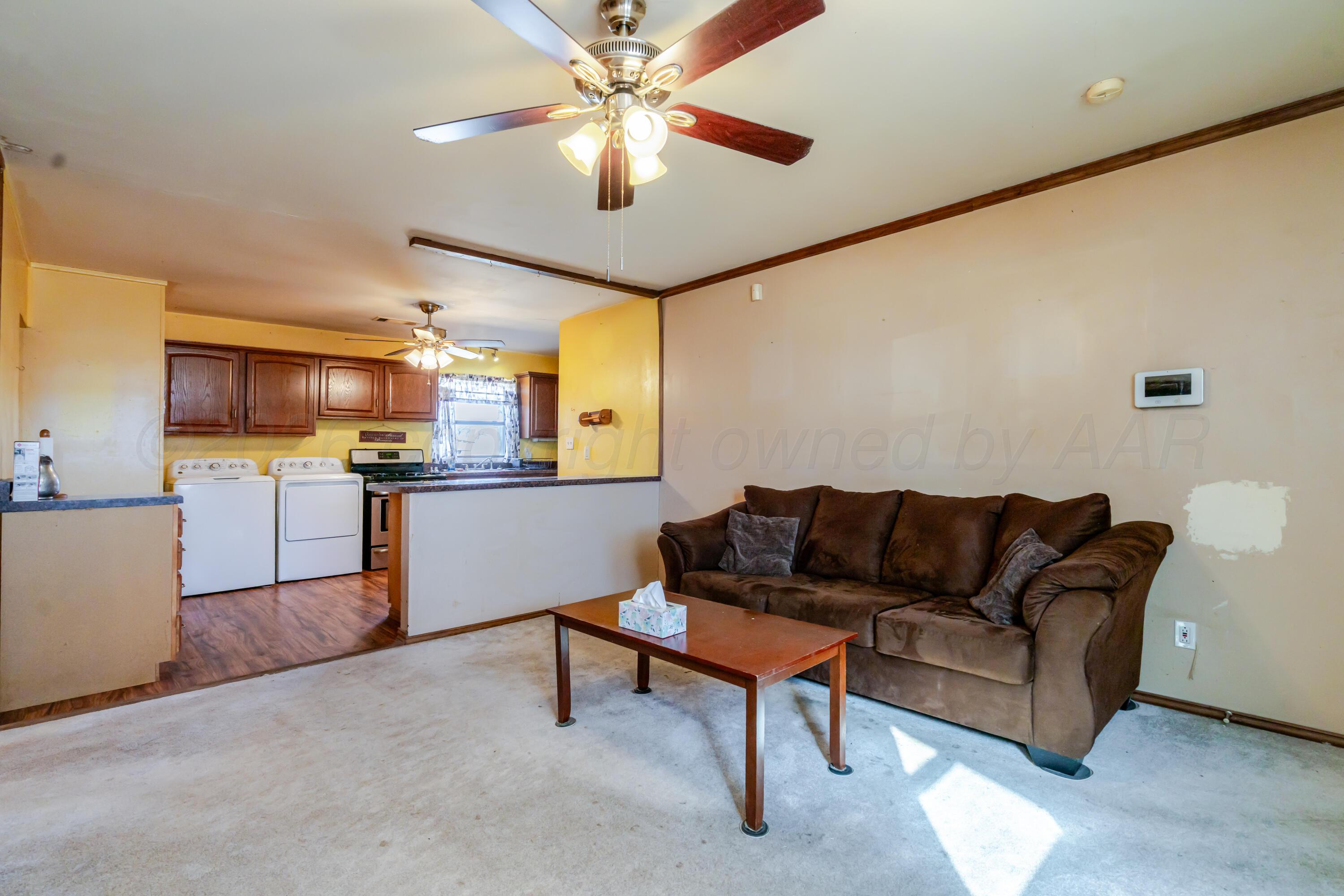 2805 Palm Street Amarillo, TX 79107 - Photo 2 of 17 a living room with furniture and kitchen view