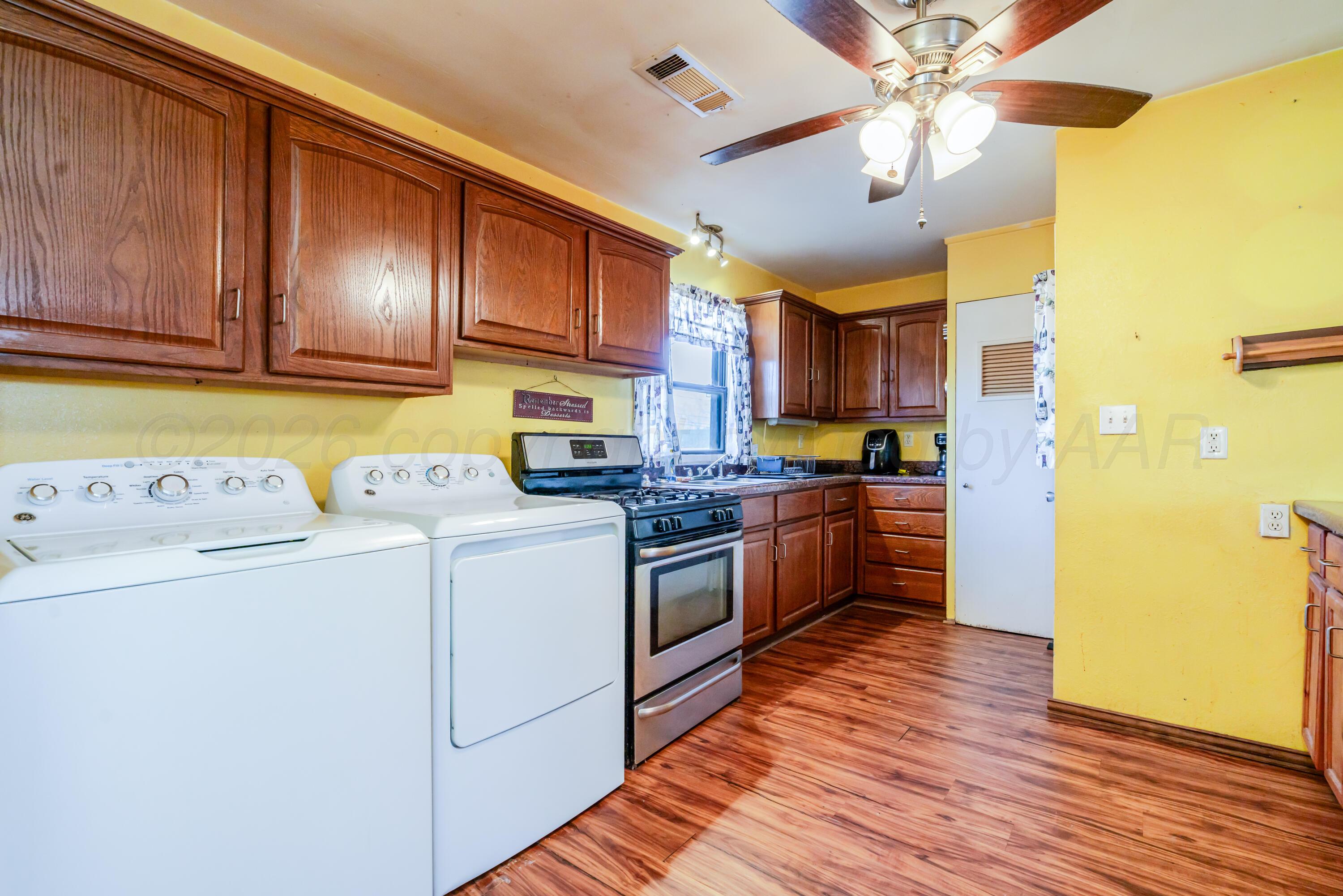 2805 Palm Street Amarillo, TX 79107 - Photo 3 of 17 a kitchen with kitchen island wooden cabinets and stainless steel appliances