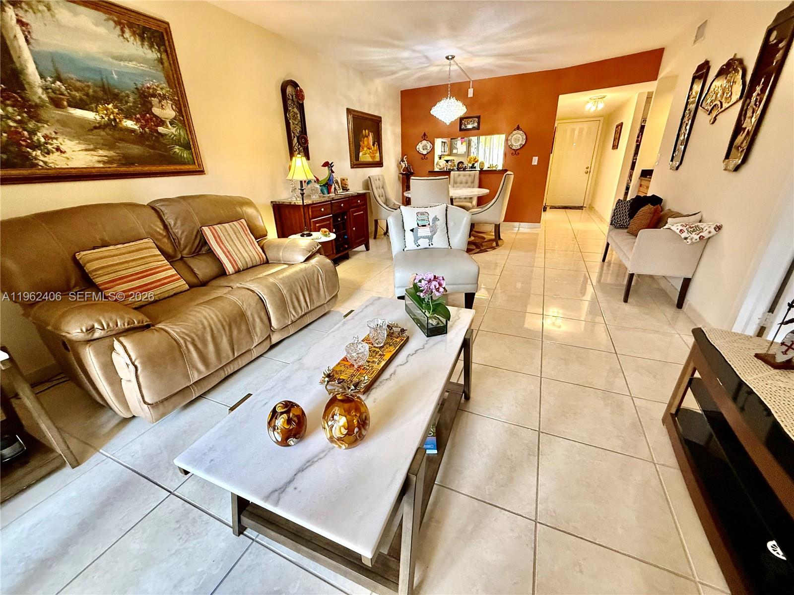 351 Club Circle, Unit 102 Boca Raton, FL 33487 - Photo 12 of 34 a living room with furniture and a flat screen tv