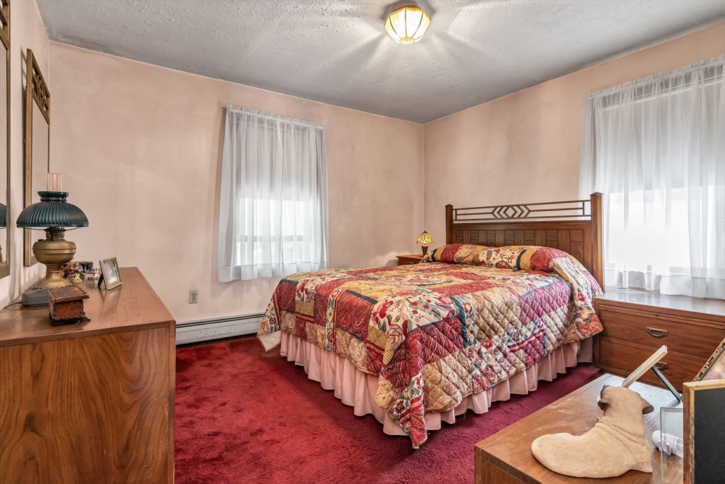 136 Vane Street Revere, MA 02151 - Photo 17 of 30 a bedroom with a bed and a couch