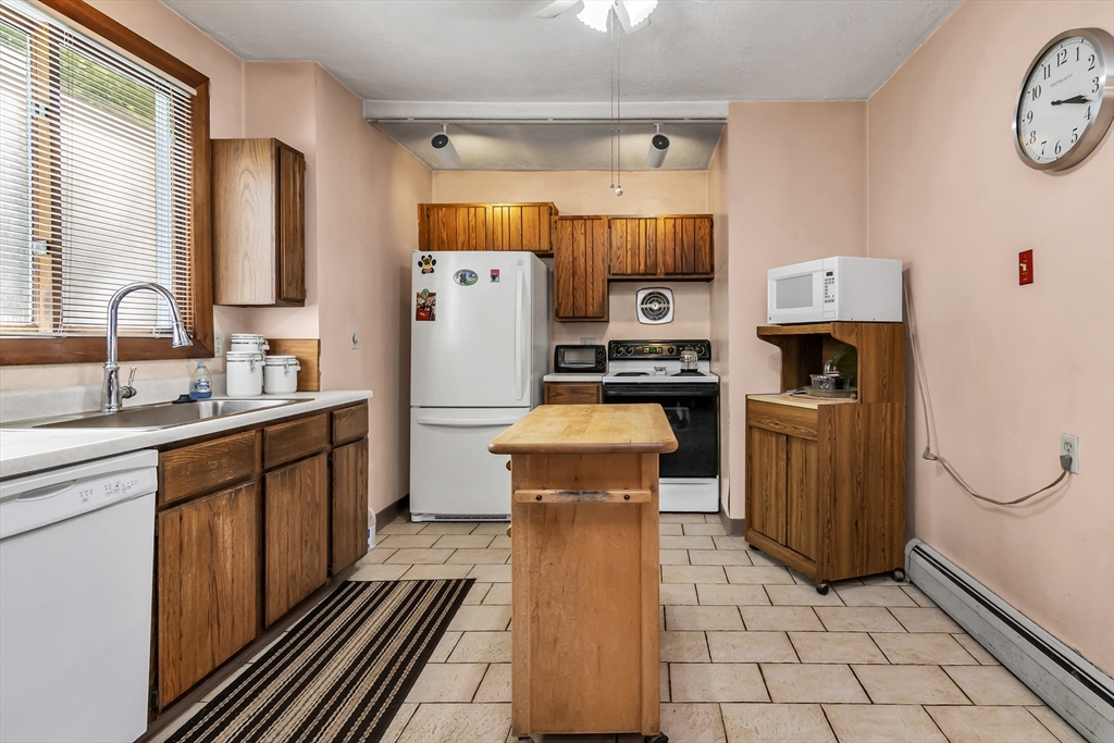 136 Vane Street Revere, MA 02151 - Photo 9 of 30 a kitchen with a refrigerator a stove top oven and a sink