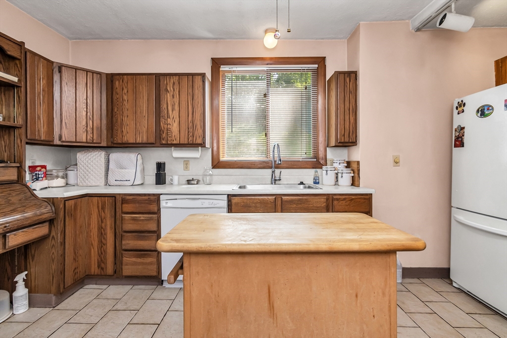 136 Vane Street Revere, MA 02151 - Photo 10 of 30 a kitchen with stainless steel appliances granite countertop a sink stove and refrigerator