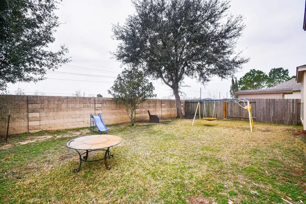 a backyard of a house with table and chairs