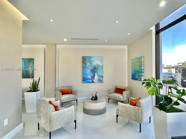a living room with furniture and flowers