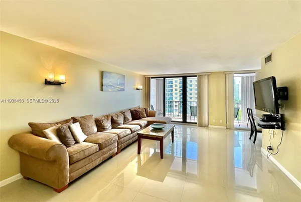 a living room with furniture and a flat screen tv
