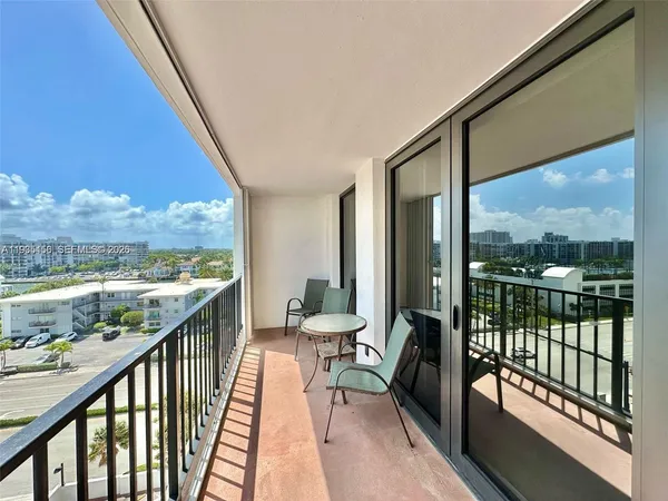 a view of a balcony with furniture and wooden floor