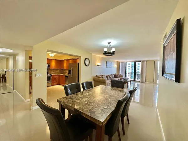 a view of a dining room with furniture and a chandelier