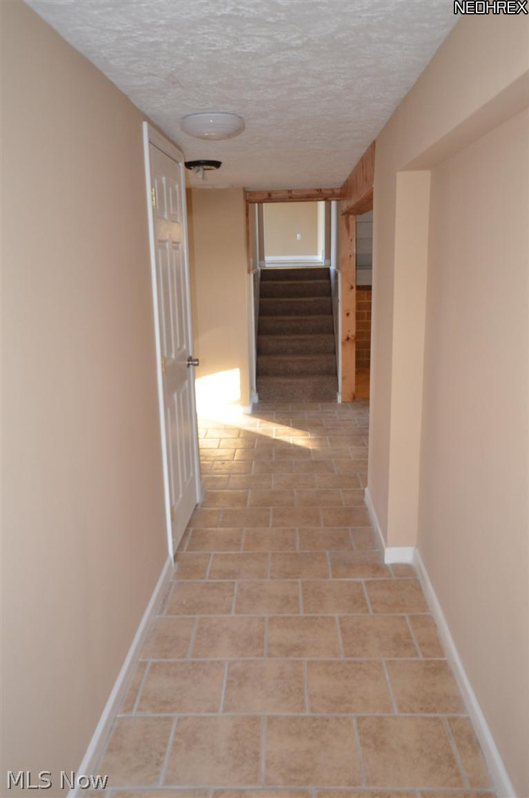 5495 Ford Road Madison, OH 44057 - Photo 8 of 15 Mudroom hallway view to staircase and partial basement