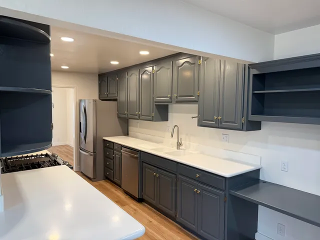 a view of a patio with table and chairs with wooden floor and fence