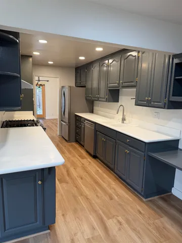 a view of a patio with table and chairs potted plants with wooden floor and fence