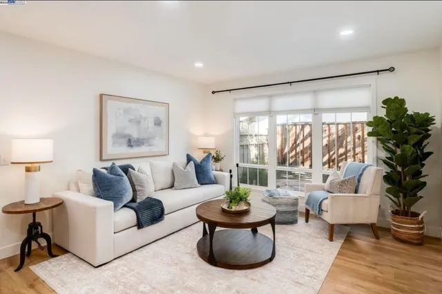 a white bed sitting in a bedroom next to a lamp