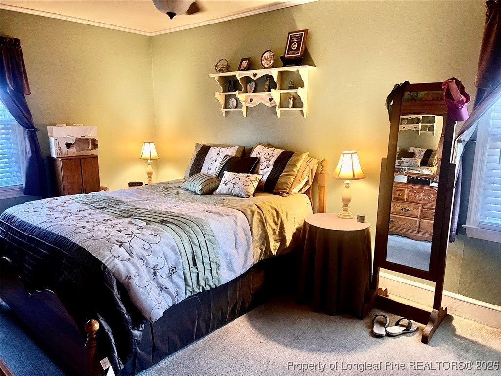 508 East Church Street Rowland, NC 28383 - Photo 2 of 6 a bedroom with a bed and wooden floor