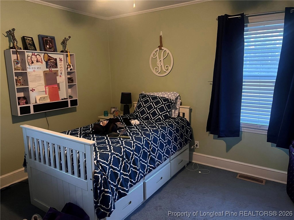 508 East Church Street Rowland, NC 28383 - Photo 3 of 6 a bedroom with bed and a window