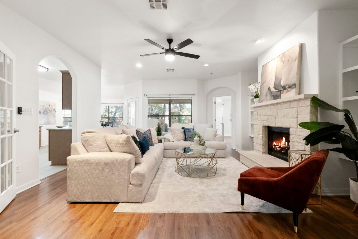 a living room with furniture fireplace and window