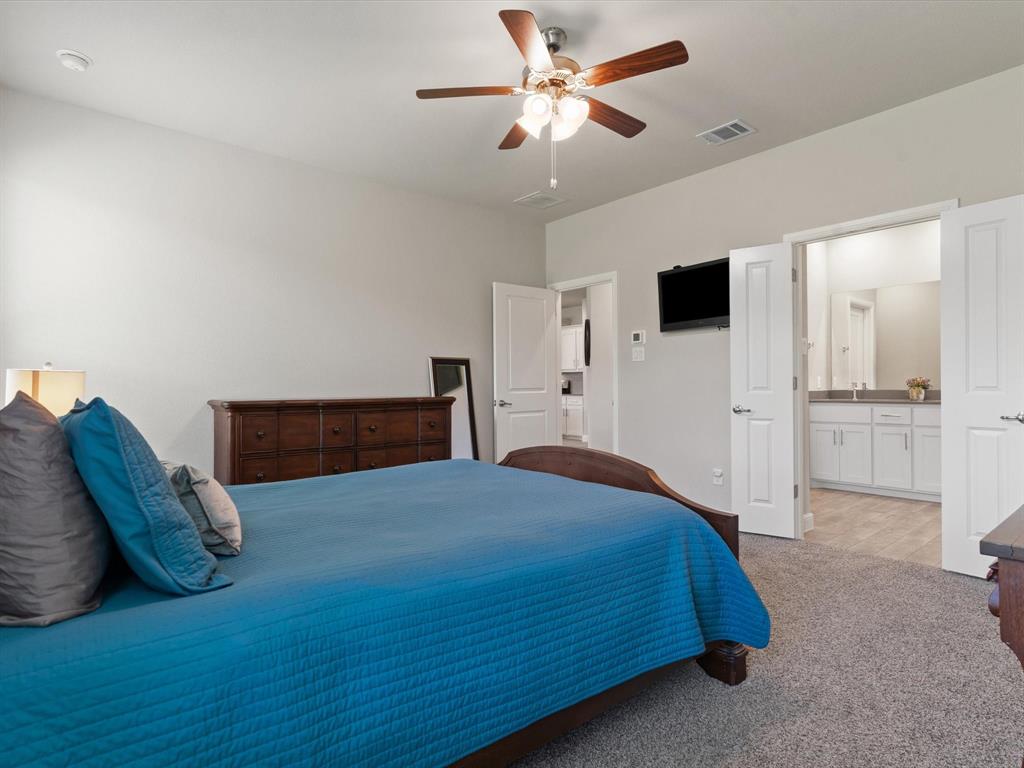 270 Lunayena Road Rhome, TX 76078 - Photo 29 of 37 The spacious primary bedroom offers a comfortable retreat with ample natural light and a well-proportioned layout, providing a private space to unwind at the end of the day.