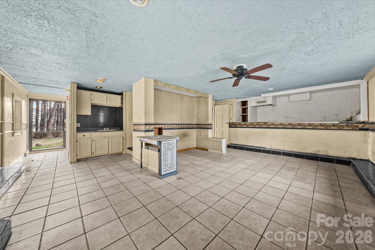 444 Craven Street Star, NC 27356 - Photo 15 of 48 a living room with a couch and a stove top oven