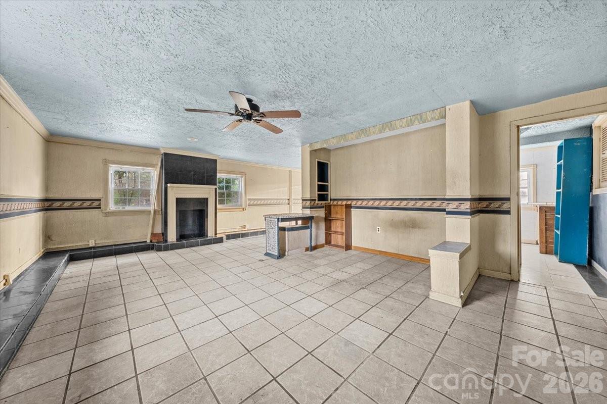 444 Craven Street Star, NC 27356 - Photo 17 of 48 a view of an empty room with a fireplace and a window