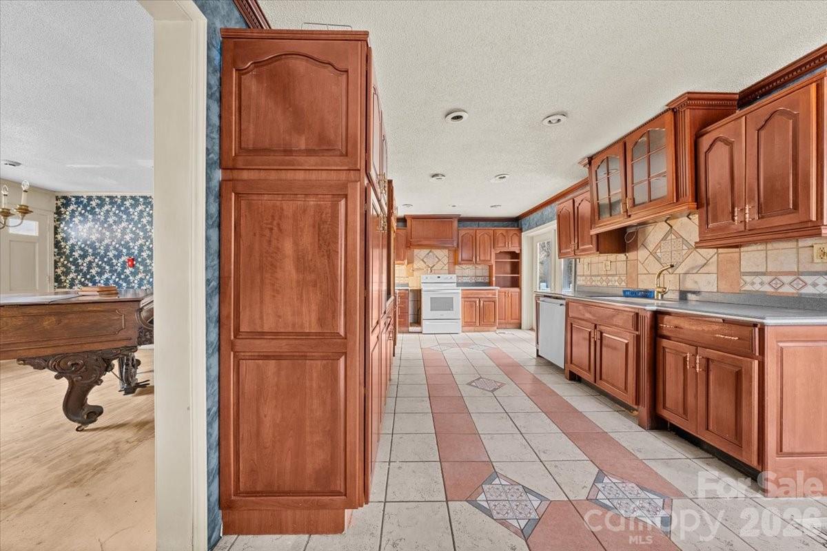 444 Craven Street Star, NC 27356 - Photo 23 of 48 a kitchen with stainless steel appliances granite countertop a refrigerator and a wooden cabinets