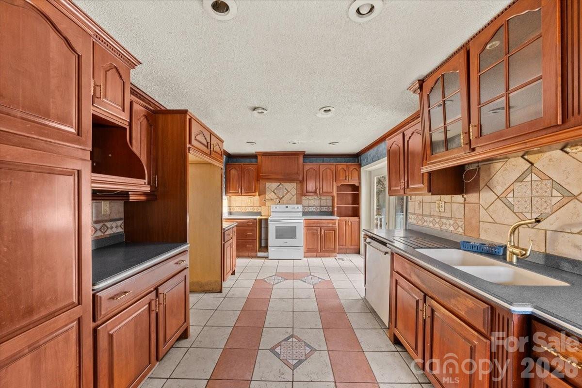 444 Craven Street Star, NC 27356 - Photo 25 of 48 a kitchen with stainless steel appliances granite countertop a refrigerator and a sink