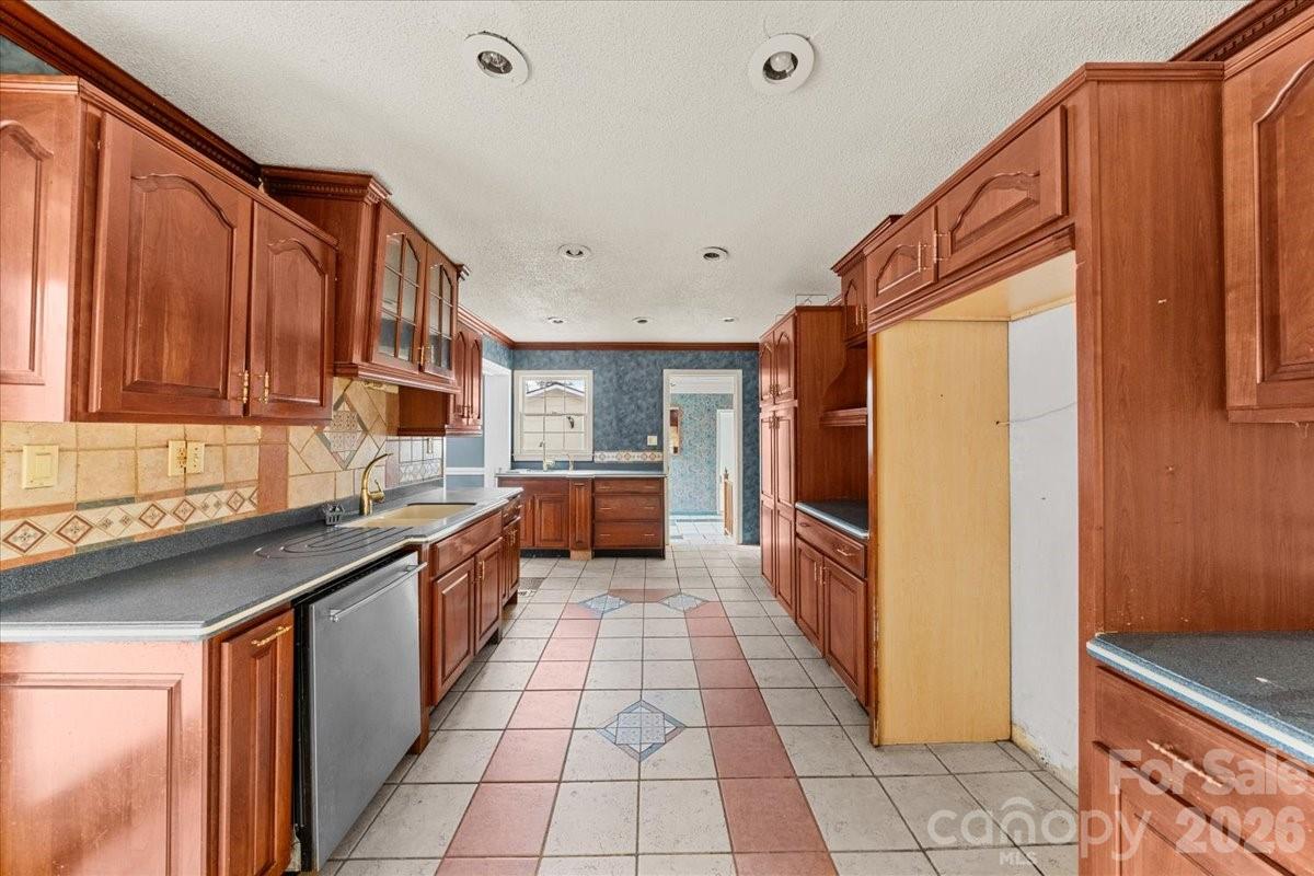 444 Craven Street Star, NC 27356 - Photo 26 of 48 a kitchen with stainless steel appliances a sink stove and cabinets