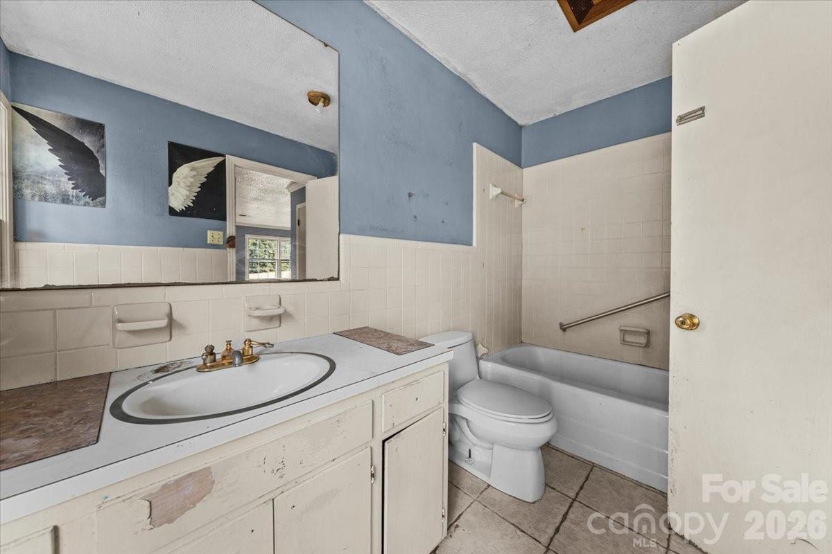 444 Craven Street Star, NC 27356 - Photo 42 of 48 a bath room with a toilet a sink and a mirror