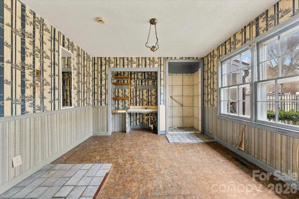 a view of an empty room with a window