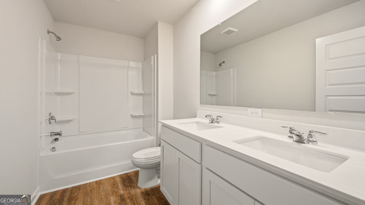 8578 Seabiscuit Road Lithonia, GA 30058 - Photo 19 of 30 a bathroom with a sink toilet tub and shower