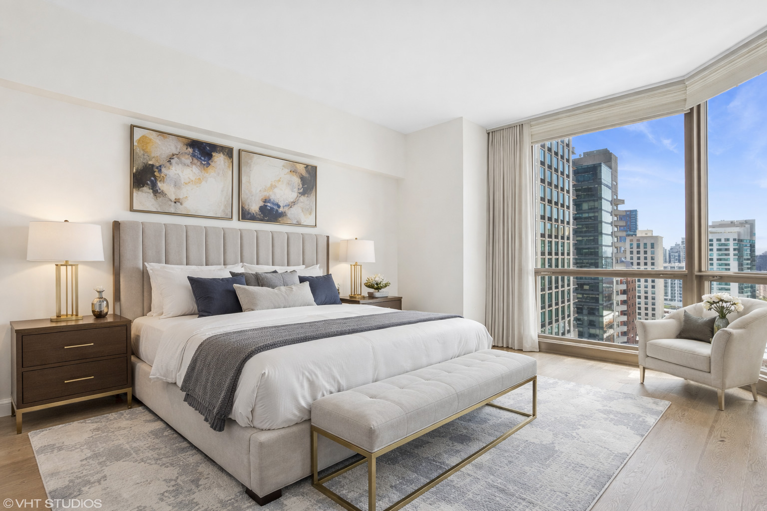 21 East Huron Street, Unit 1806 Chicago, IL 60611 - Photo 17 of 43 a bedroom with a large bed couch and two large window