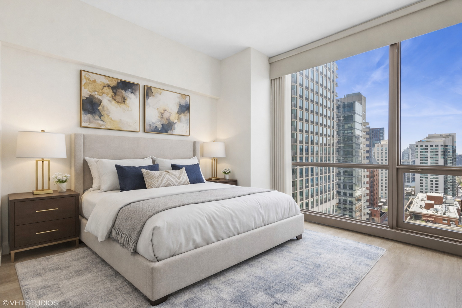 21 East Huron Street, Unit 1806 Chicago, IL 60611 - Photo 18 of 43 a bedroom with a large bed and a large window